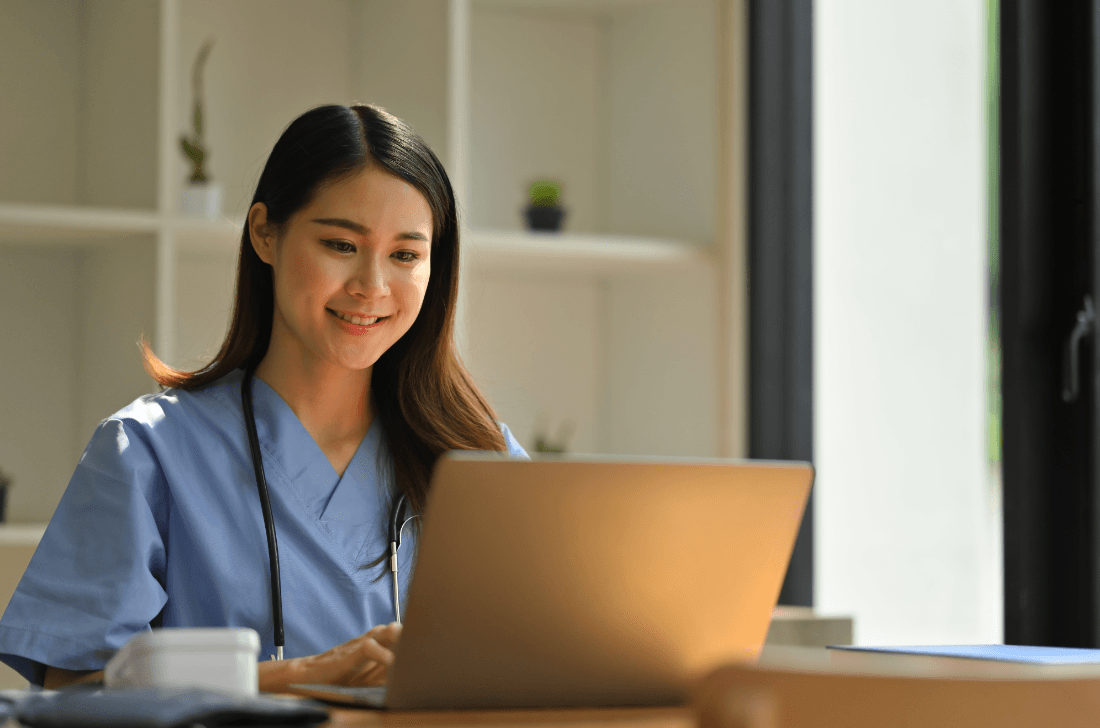 Medical coding professional working at a computer